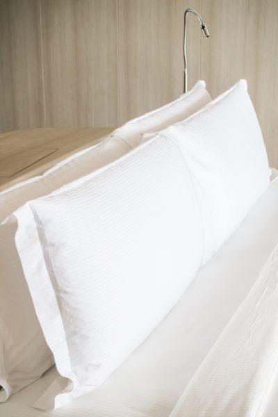 White pillow on bed decoration in bedroom interior