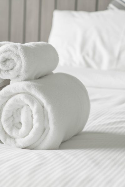 White towel on bed decoration in bedroom interior - Vintage light Filter