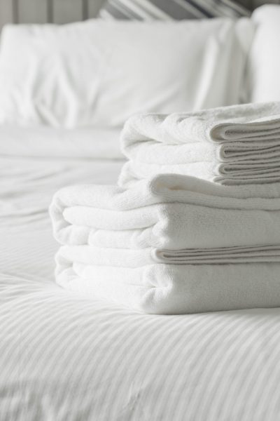 White towel on bed decoration in bedroom interior - Vintage light Filter